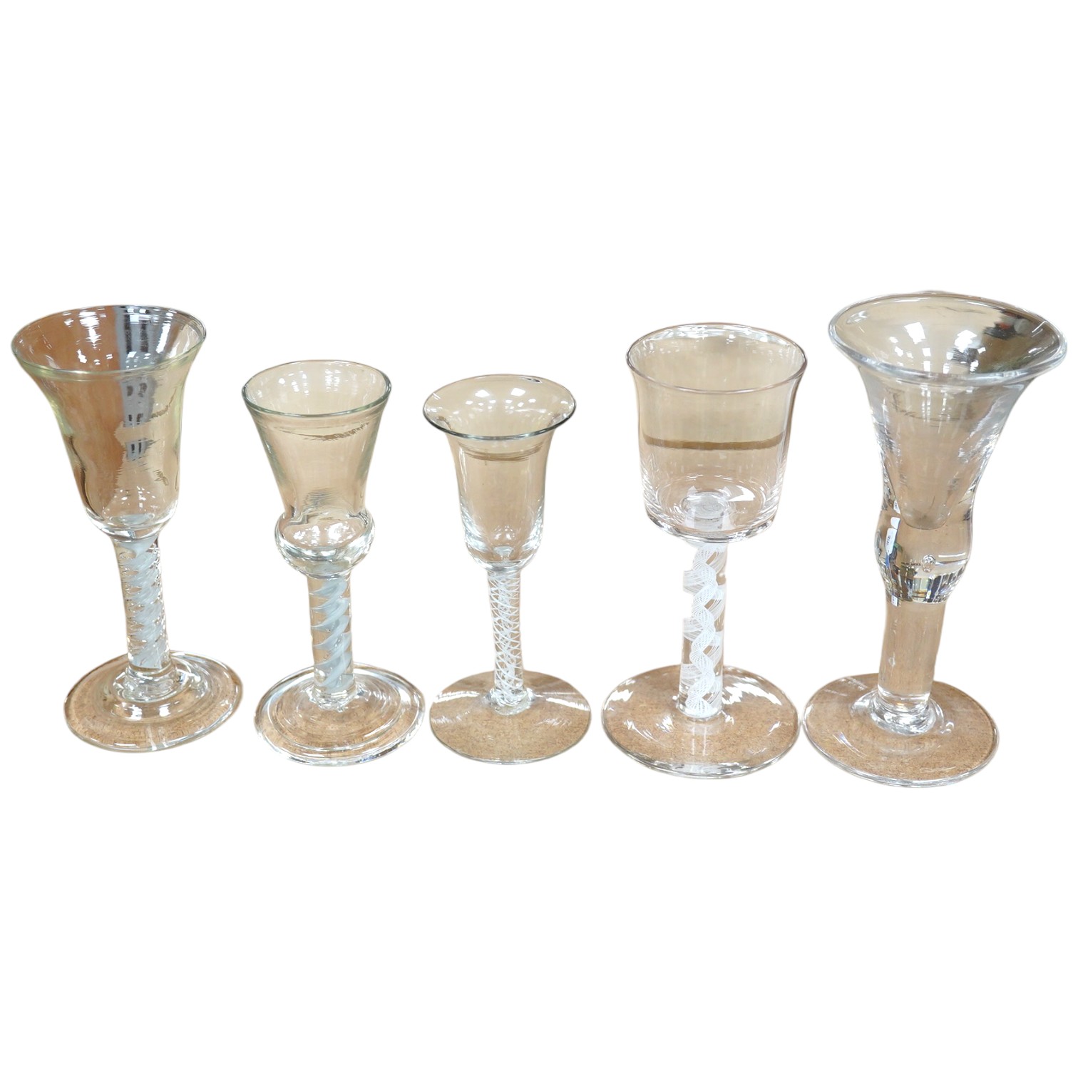 Five 18th century style wine and cordial glasses, some with air twist stems, largest 18cm high. Condition - good